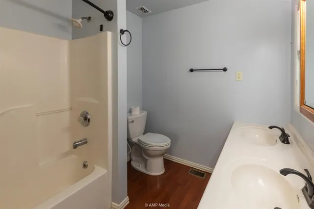 a bathroom with a granite countertop shower and a toilet