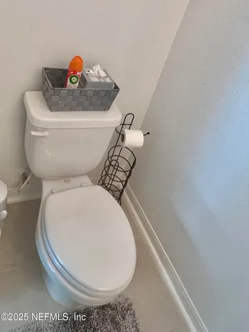 a hallway with wooden floor and stairs