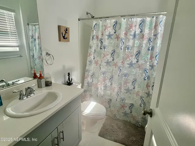 a bed sitting in a bedroom next to a lamp