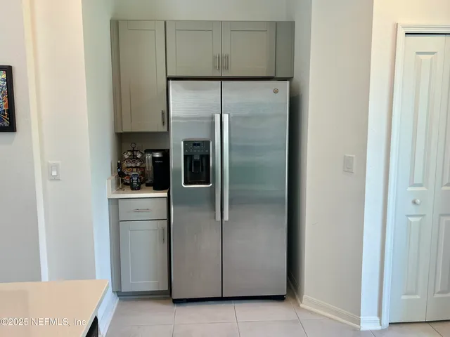 a kitchen with a refrigerator and cabinets