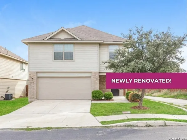 a sign that is sitting in front of a house