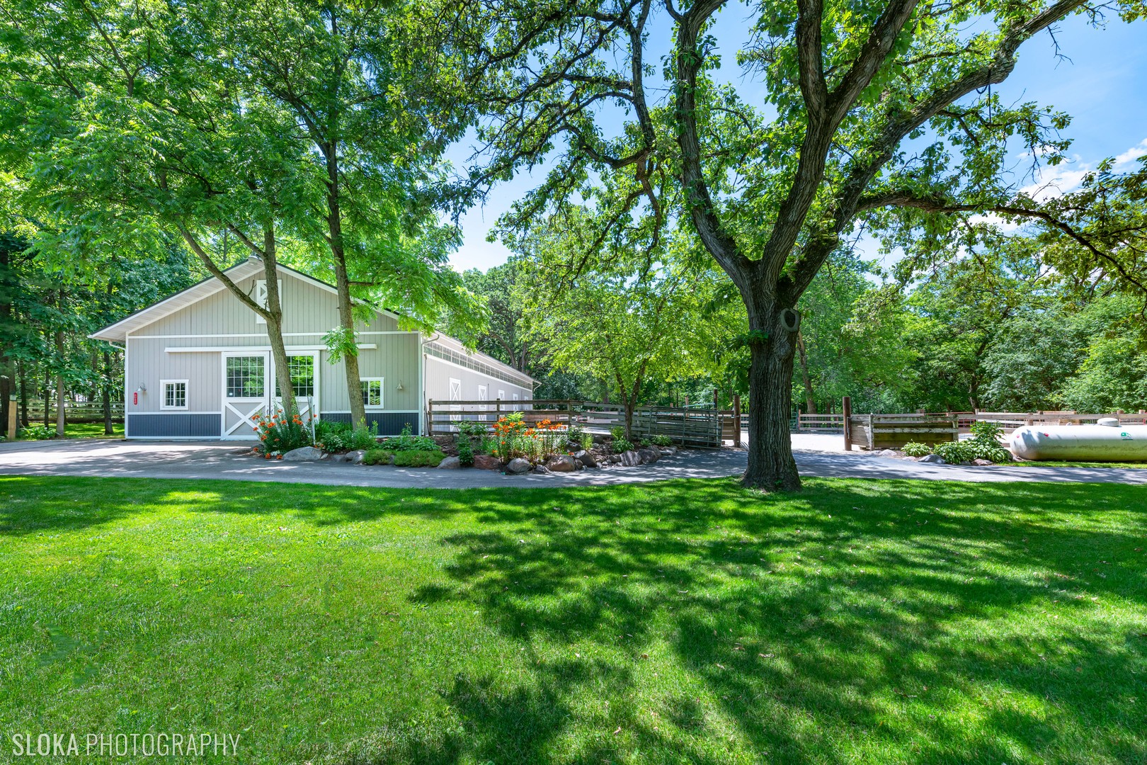 7812 East Tryon Grove Road Richmond, IL 60071 - Photo 36 of 55 a front view of a house with a garden and trees