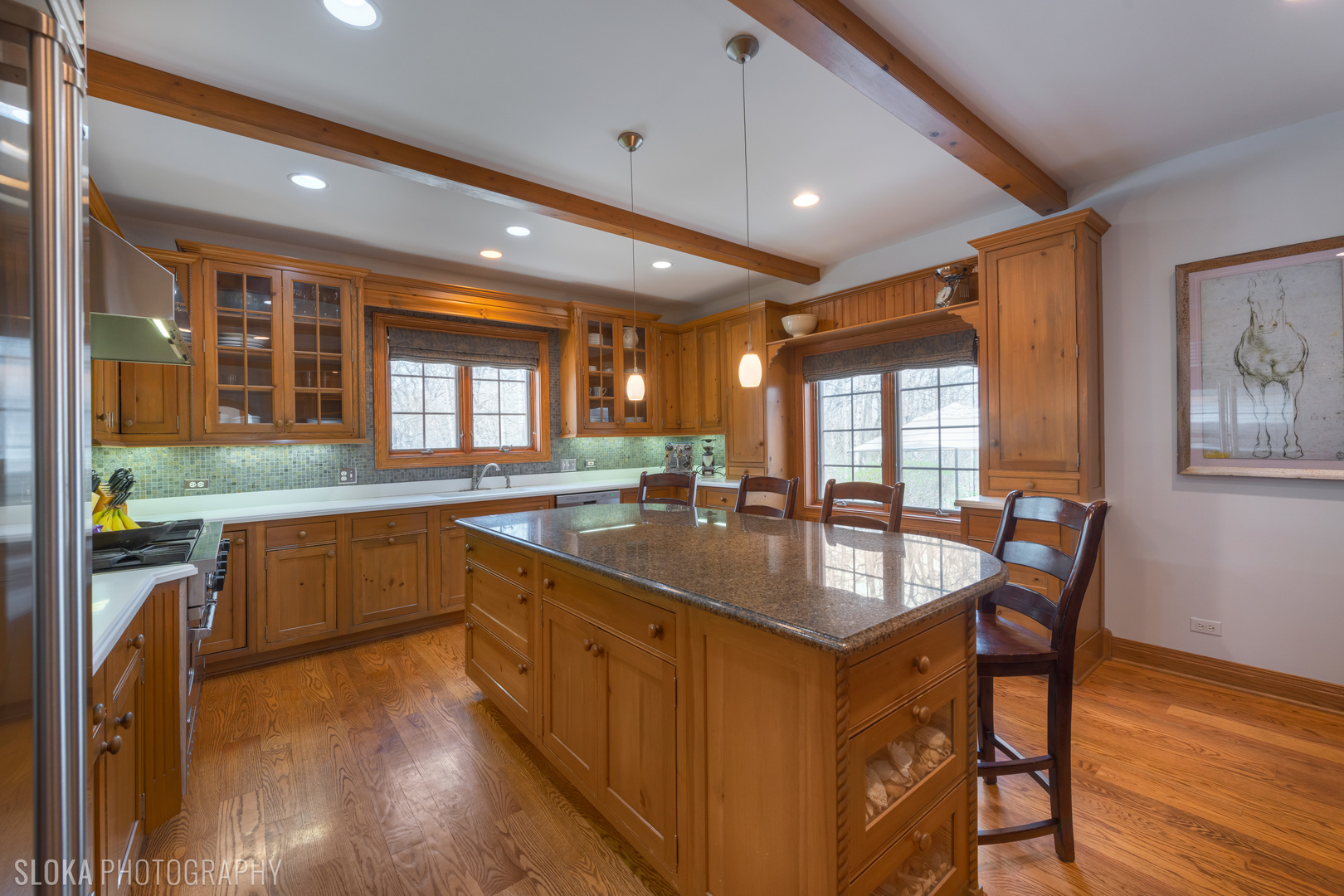 7812 East Tryon Grove Road Richmond, IL 60071 - Photo 9 of 55 a kitchen with granite countertop white cabinets and wooden floor