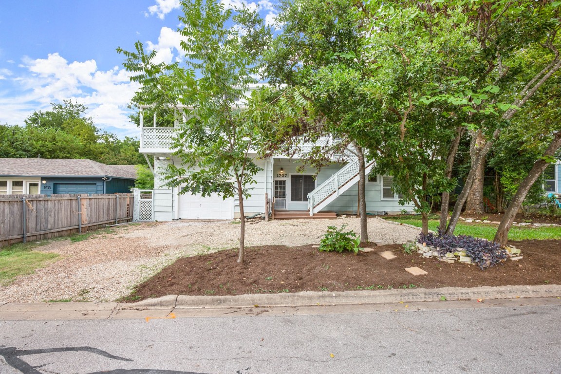 Obstructed view of property featuring driveway and a garage