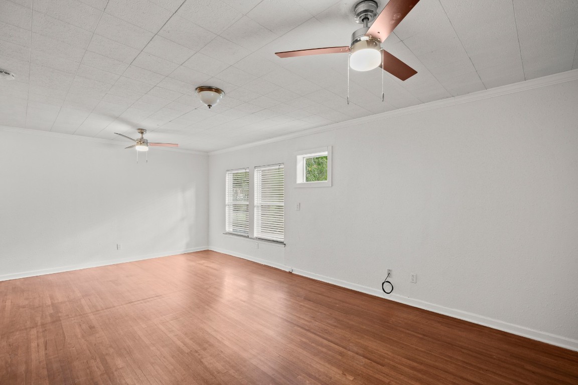 1707 Alguno Road, Unit C Austin, TX 78757 - Photo 11 of 16 molding, ceiling fan, and wood finished floors