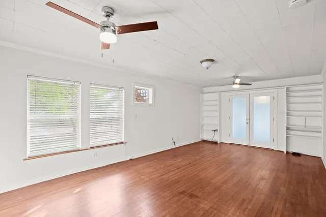 a view of a kitchen with a sink dishwasher a kitchen view with wooden floor and cabinets