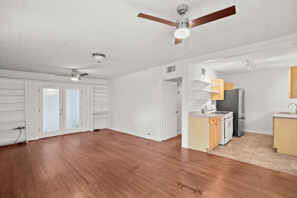 1707 Alguno Road, Unit C Austin, TX 78757 - Photo 13 of 16 Unfurnished living room with french doors, light wood-style flooring, and a ceiling fan