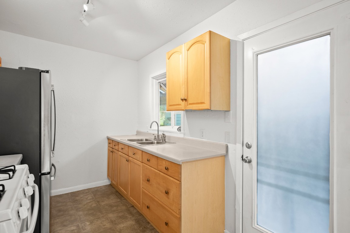 1707 Alguno Road, Unit C Austin, TX 78757 - Photo 15 of 16 Kitchen with light brown cabinets, light countertops, and gas range gas stove