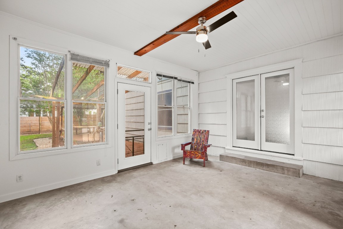 1707 Alguno Road, Unit C Austin, TX 78757 - Photo 8 of 16 Unfurnished sunroom featuring a ceiling fan, DOG door, a patio, and french doors