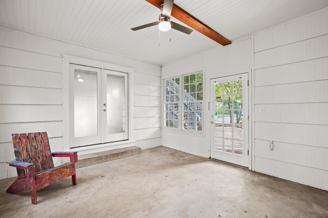 1707 Alguno Road, Unit C Austin, TX 78757 - Photo 9 of 16 Unfurnished sunroom with french doors, DOG door, ceiling fan, and a patio area