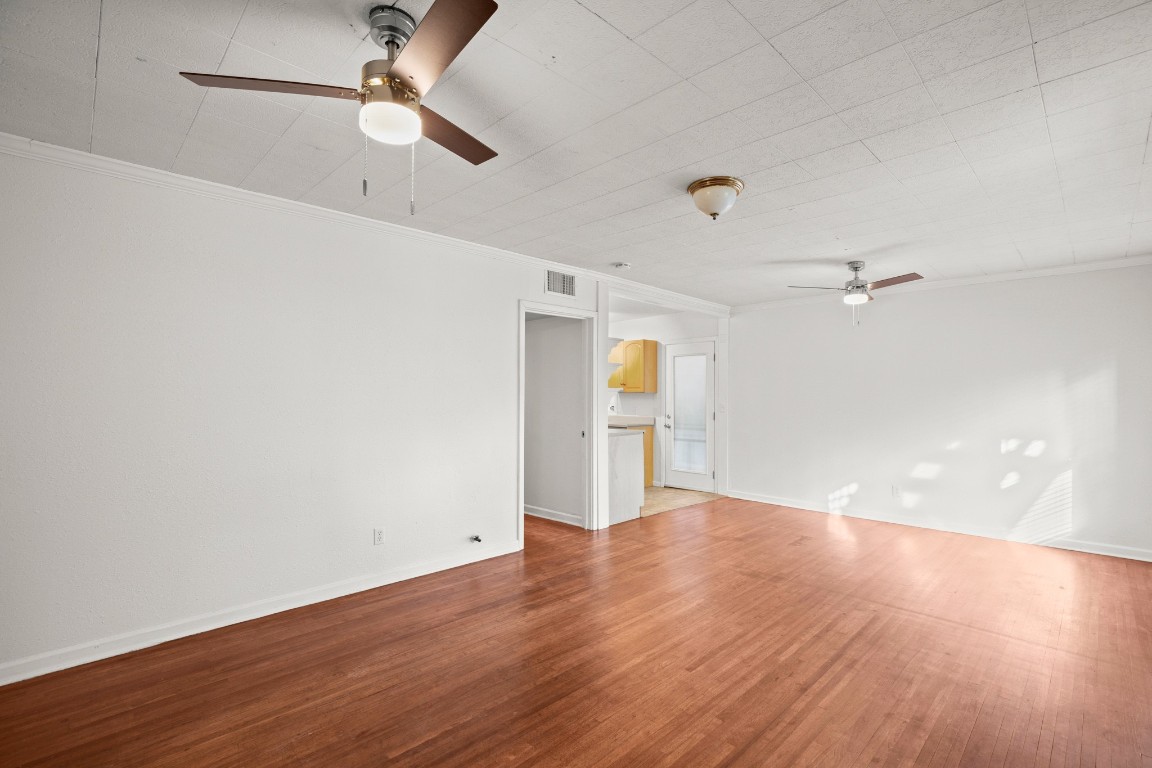1707 Alguno Road, Unit C Austin, TX 78757 - Photo 10 of 16 With a ceiling fan, crown molding, and wood finished floors