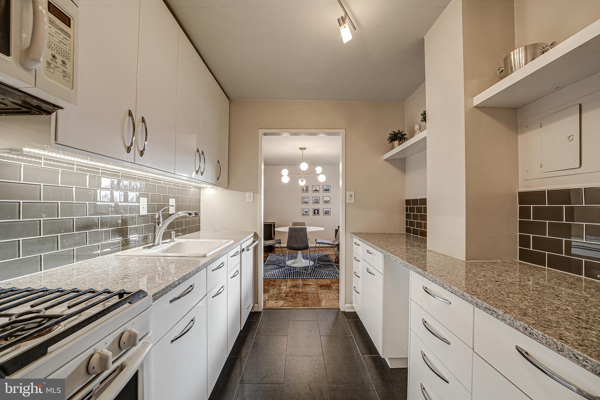 2939 Van Ness Street Northwest, Unit 1126 Washington, DC 20008 - Photo 8 of 31 a large kitchen with a lot of counter space and a sink