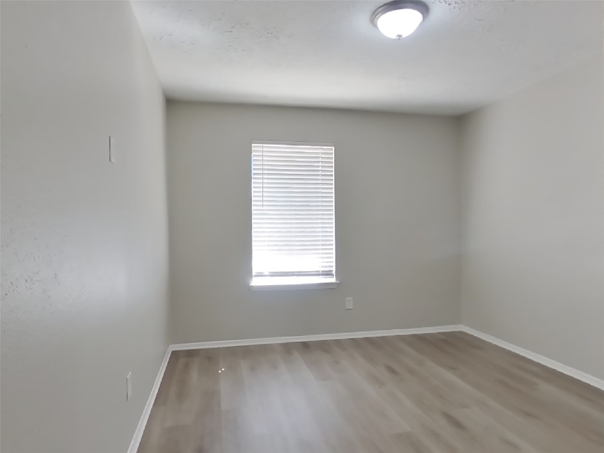 4511 Burkegate Drive Spring, TX 77373 - Photo 14 of 20 an empty room with wooden floor and windows