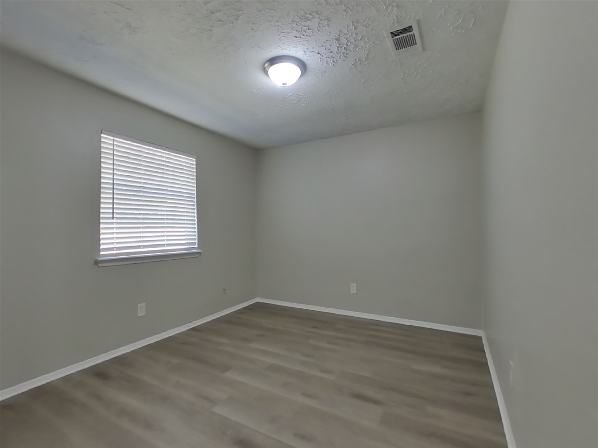 4511 Burkegate Drive Spring, TX 77373 - Photo 16 of 20 wooden floor in an empty room with a window