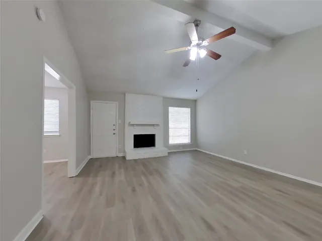 wooden floor in an empty room with a fireplace