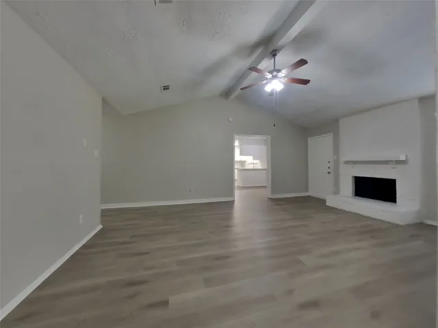 wooden floor in an empty room with a fireplace