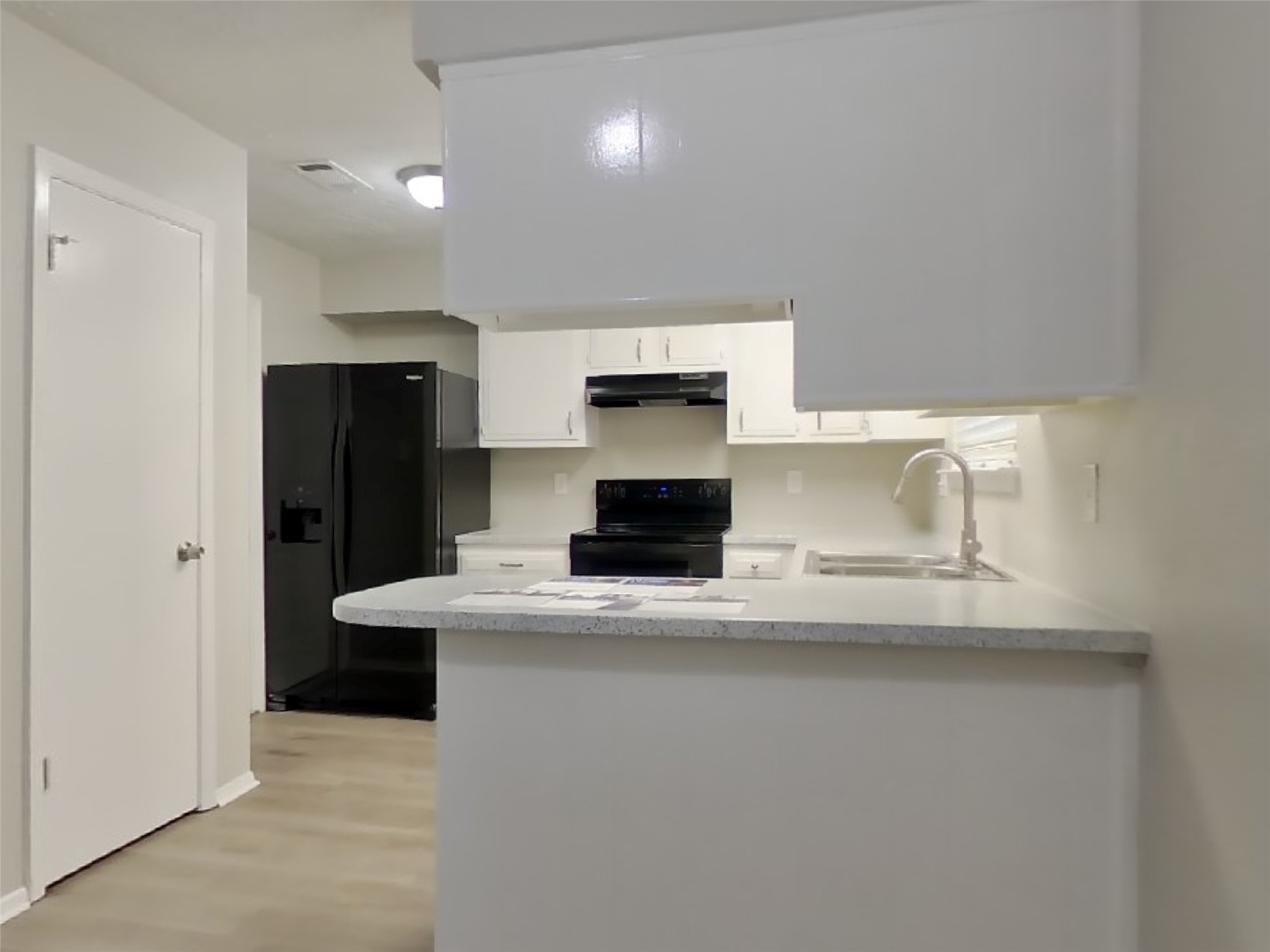 4511 Burkegate Drive Spring, TX 77373 - Photo 7 of 20 a kitchen with kitchen island a sink and refrigerator