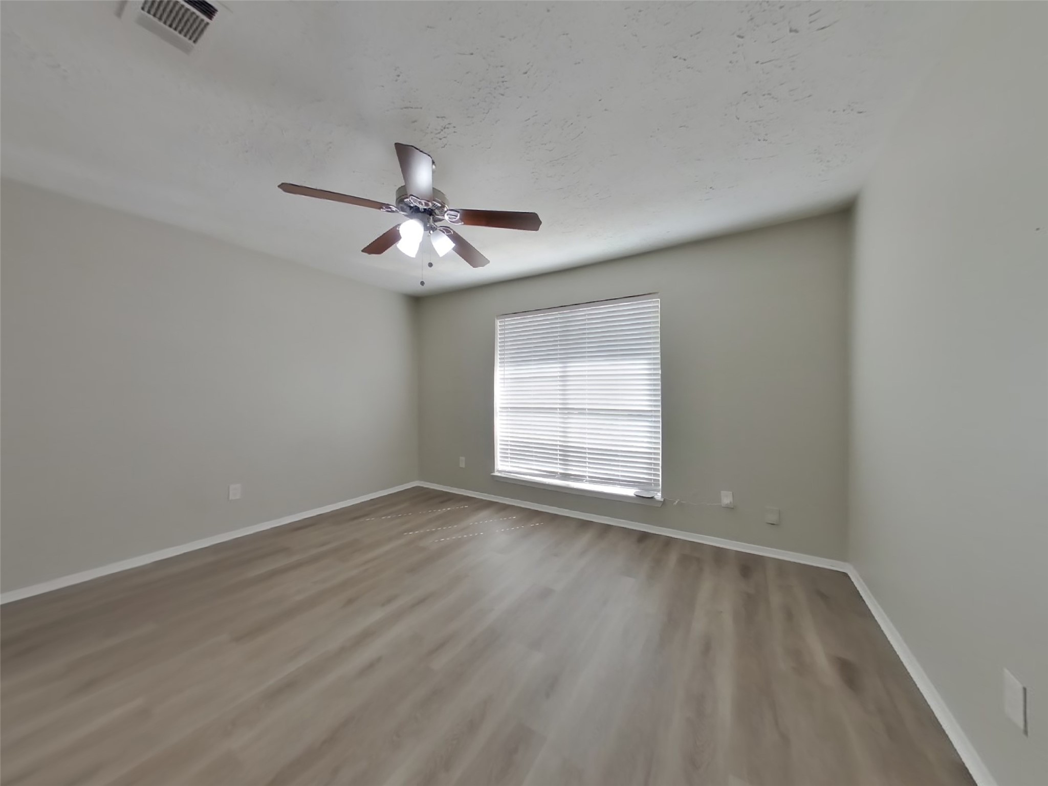 4511 Burkegate Drive Spring, TX 77373 - Photo 9 of 20 wooden floor in an empty room with a window