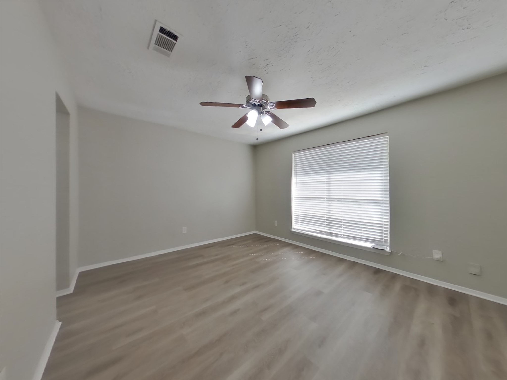 4511 Burkegate Drive Spring, TX 77373 - Photo 10 of 20 an empty room with wooden floor and windows