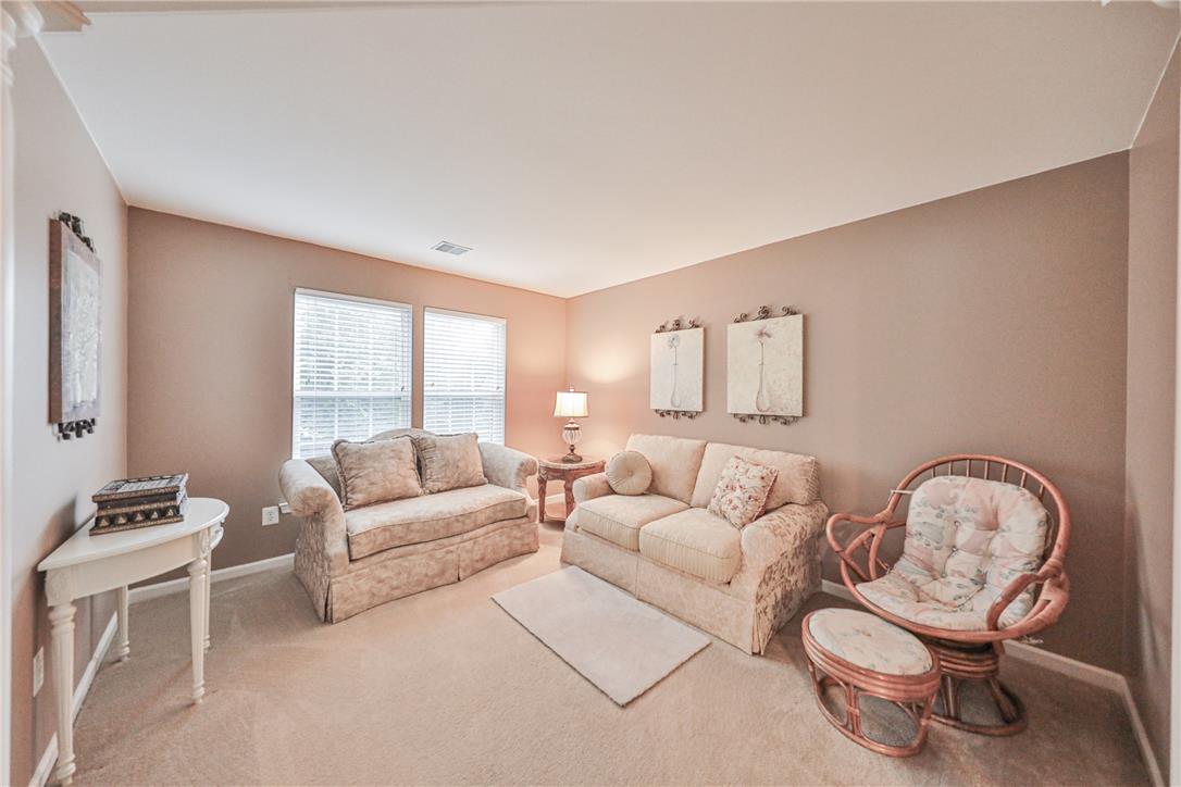 138 Clover Hollow Road Easton, PA 18045 - Photo 37 of 95 Well-lit living room offering comfortable seating and carpeted floors, creating a cozy atmosphere.