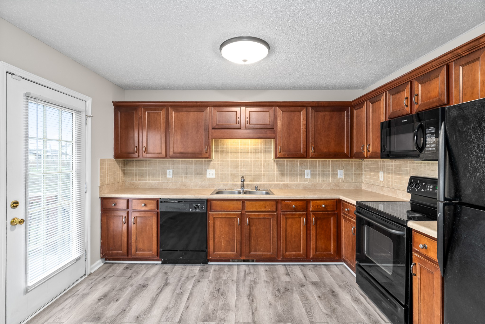 103 Meridians Way Oak Grove, KY 42262 - Photo 11 of 32 a kitchen with stainless steel appliances granite countertop wooden cabinets a sink and a stove