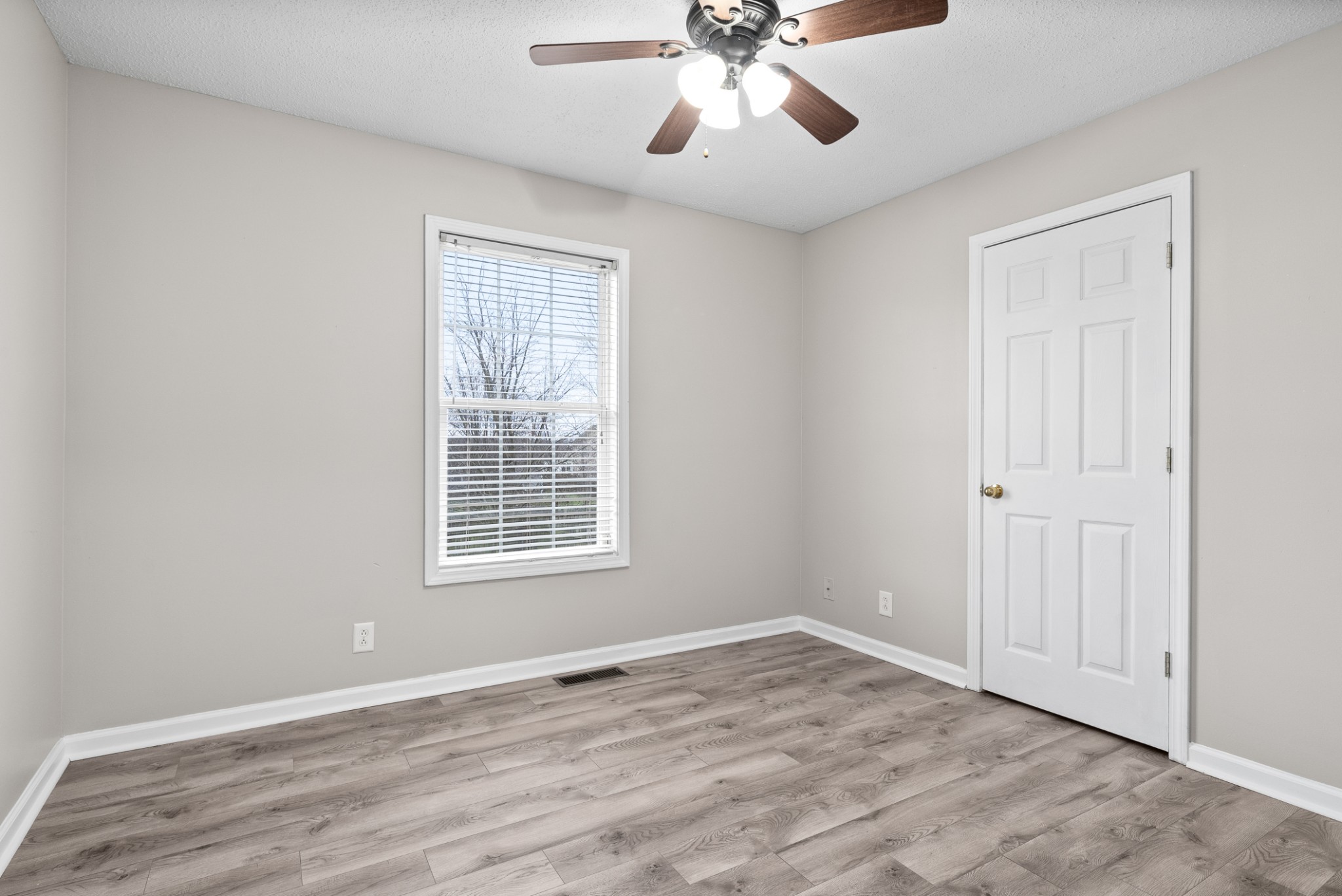 103 Meridians Way Oak Grove, KY 42262 - Photo 22 of 32 a view of an empty room with a window and wooden floor