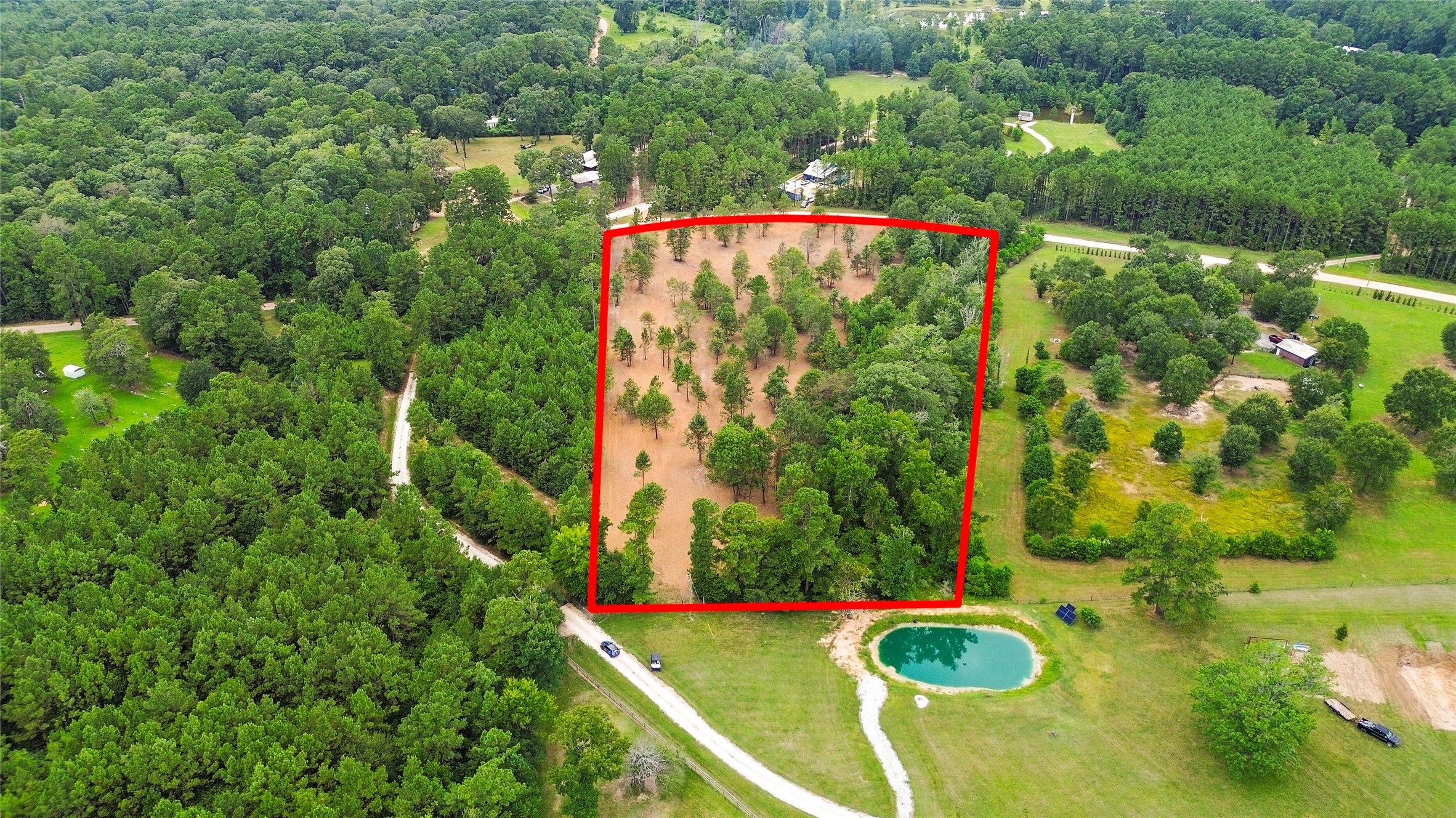 Tbd Big Woods Road New Waverly, TX 77358 - Photo 1 of 11 an aerial view of a house with swimming pool and large trees