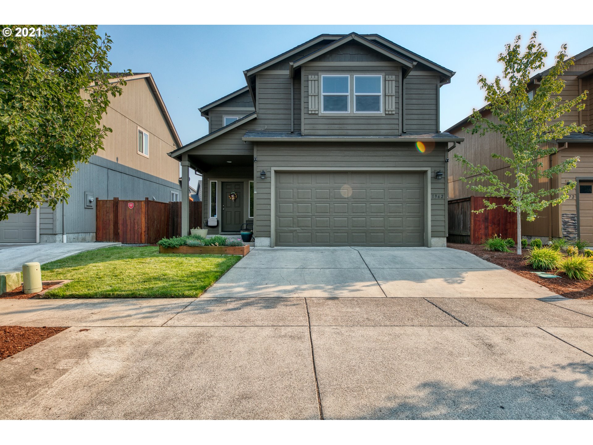 1962 Adelman Loop Eugene, OR 97402 - Photo 1 of 22 a front view of a house with a yard and garage