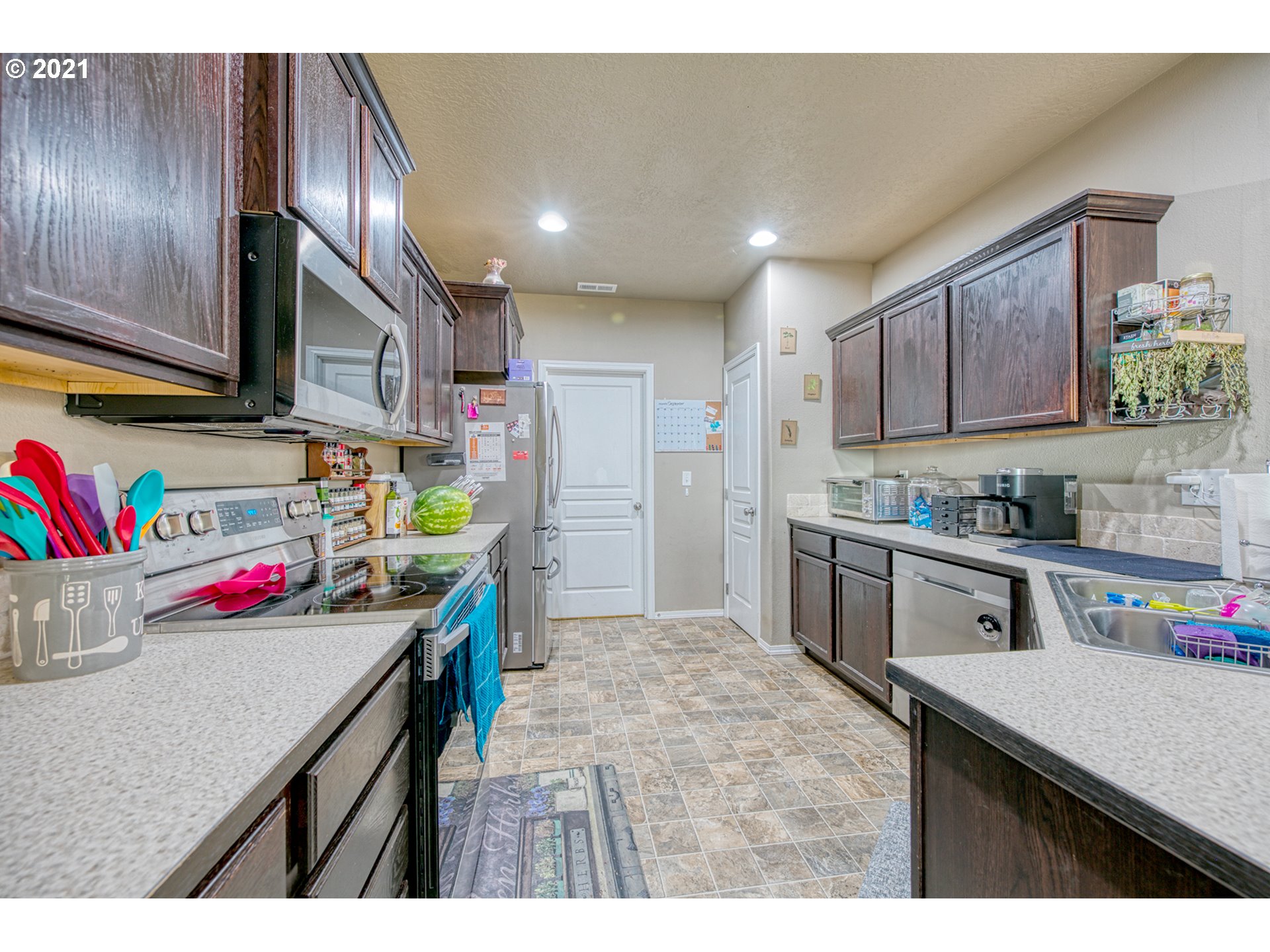 1962 Adelman Loop Eugene, OR 97402 - Photo 6 of 22 a kitchen that has a lot of cabinets a sink and wooden floor