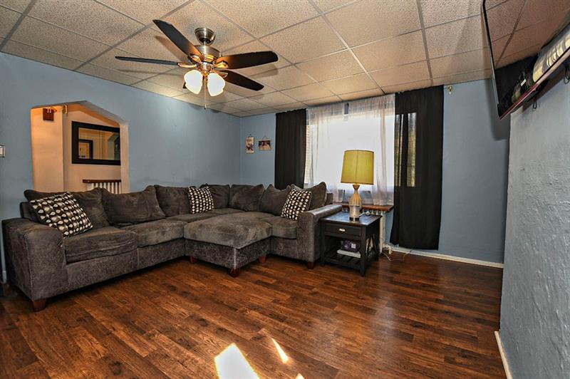 2315 Mt Troy Road Pittsburgh, PA 15212 - Photo 3 of 18 LIVING ROOM - Main level living area with wood look vinyl flooring, ceiling fan with light fixture.