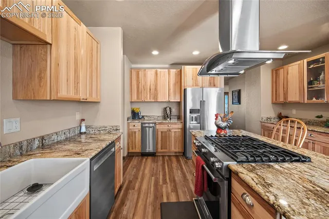 a kitchen with a sink stove top oven and cabinets