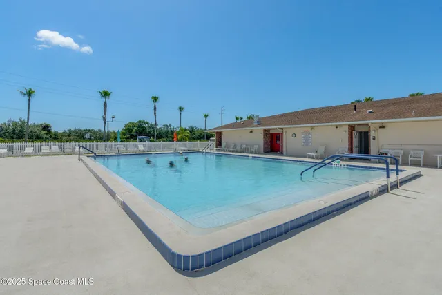 swimming pool with outdoor seating and plants