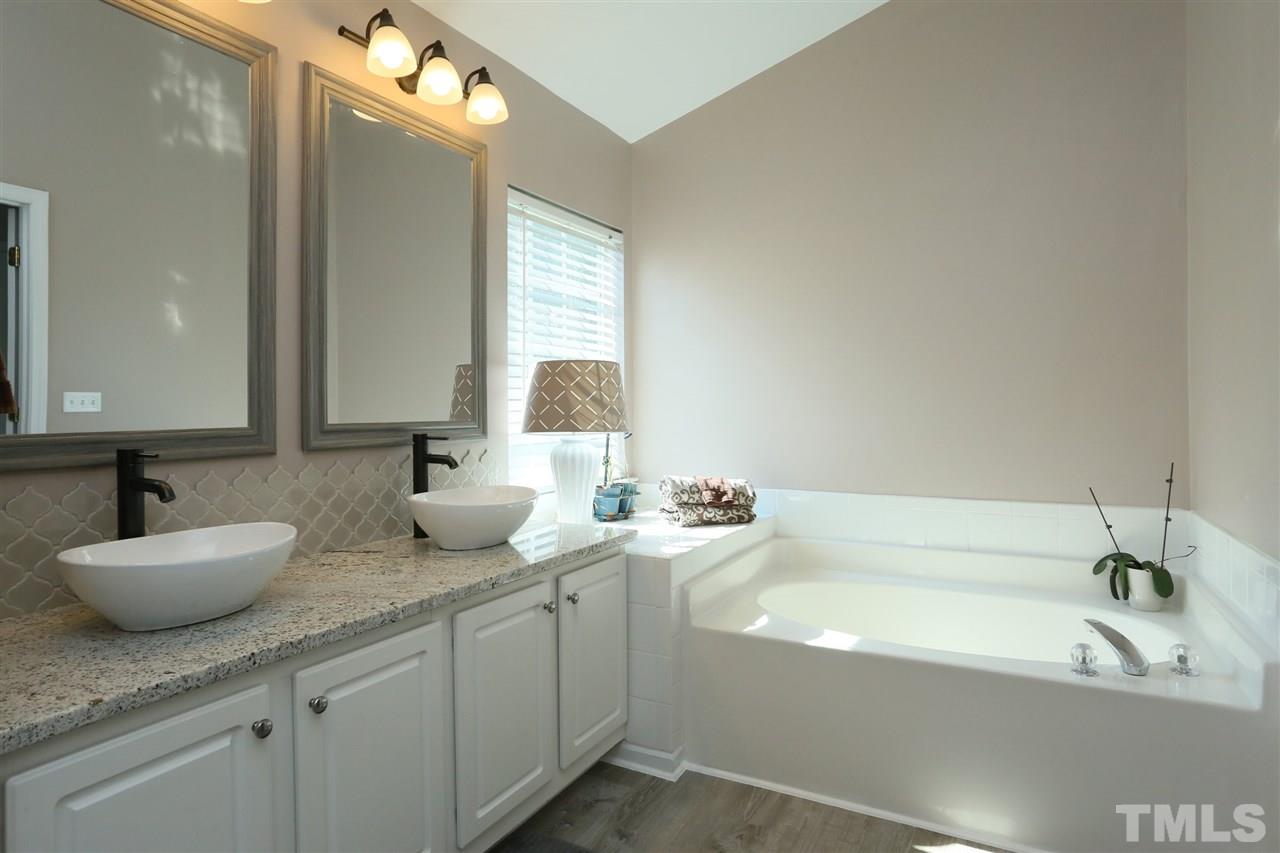 301 Burrell Road Durham, NC 27703 - Photo 14 of 30 a bathroom with a granite countertop sink mirror and bathtub
