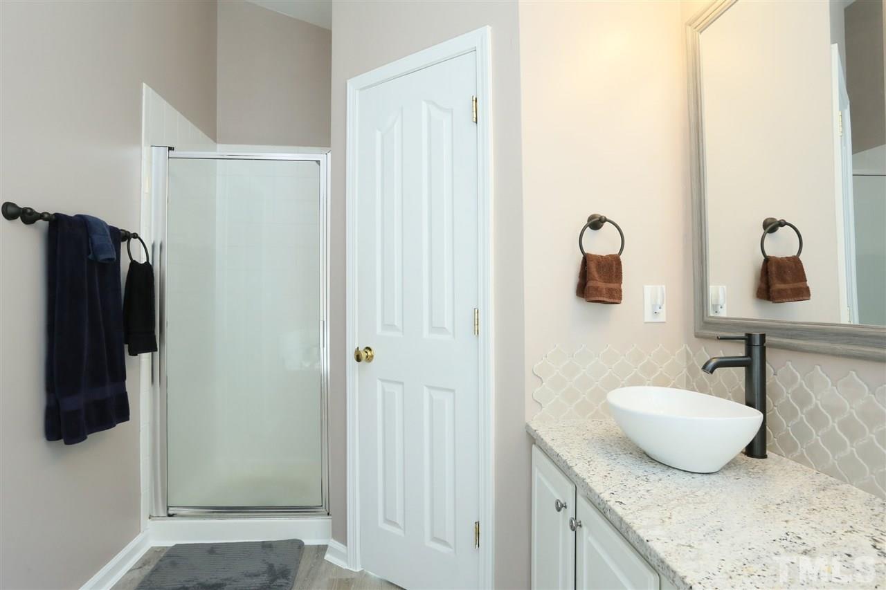301 Burrell Road Durham, NC 27703 - Photo 16 of 30 a bathroom with a granite countertop sink and a mirror