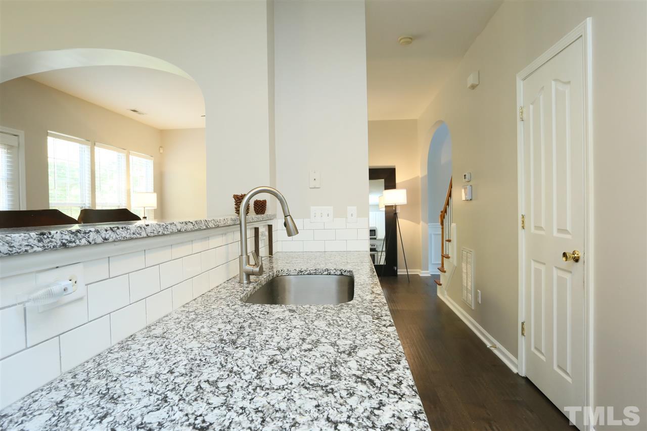 301 Burrell Road Durham, NC 27703 - Photo 6 of 30 a kitchen with a sink and a refrigerator