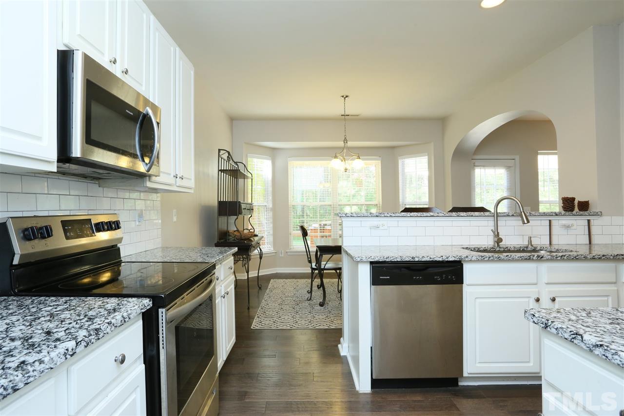 301 Burrell Road Durham, NC 27703 - Photo 7 of 30 a kitchen with stainless steel appliances granite countertop a stove a sink and a microwave