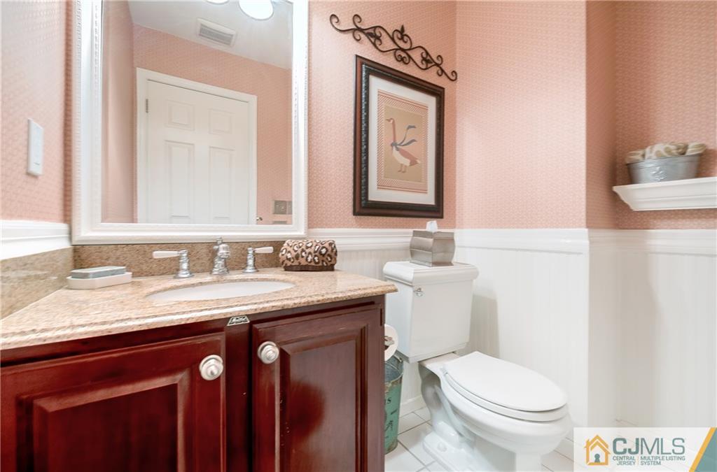 3 Old Road Monroe Township, NJ 08831 - Photo 12 of 25 a bathroom with a granite countertop toilet sink and mirror