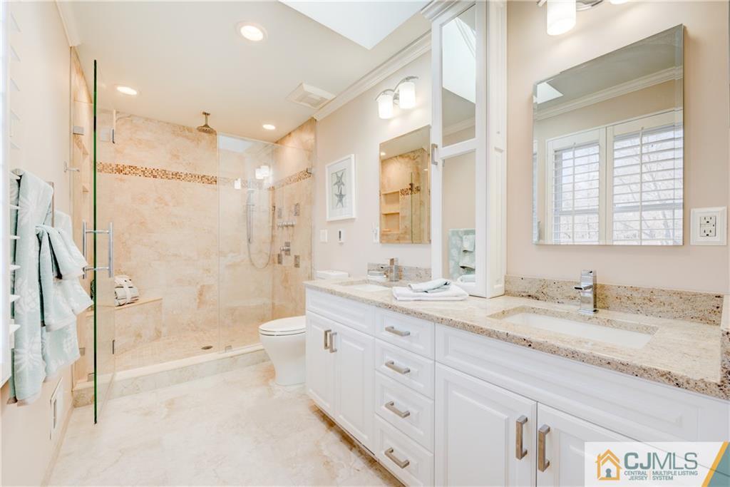 3 Old Road Monroe Township, NJ 08831 - Photo 16 of 25 a bathroom with a granite countertop sink a toilet a mirror and shower