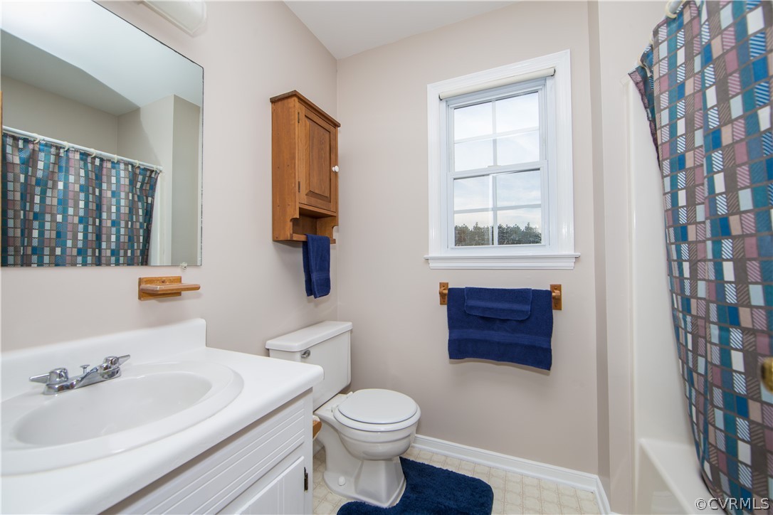 7760 Drexelbrook Road Chesterfield, VA 23832 - Photo 16 of 24 a bathroom with a sink a toilet and shower curtain