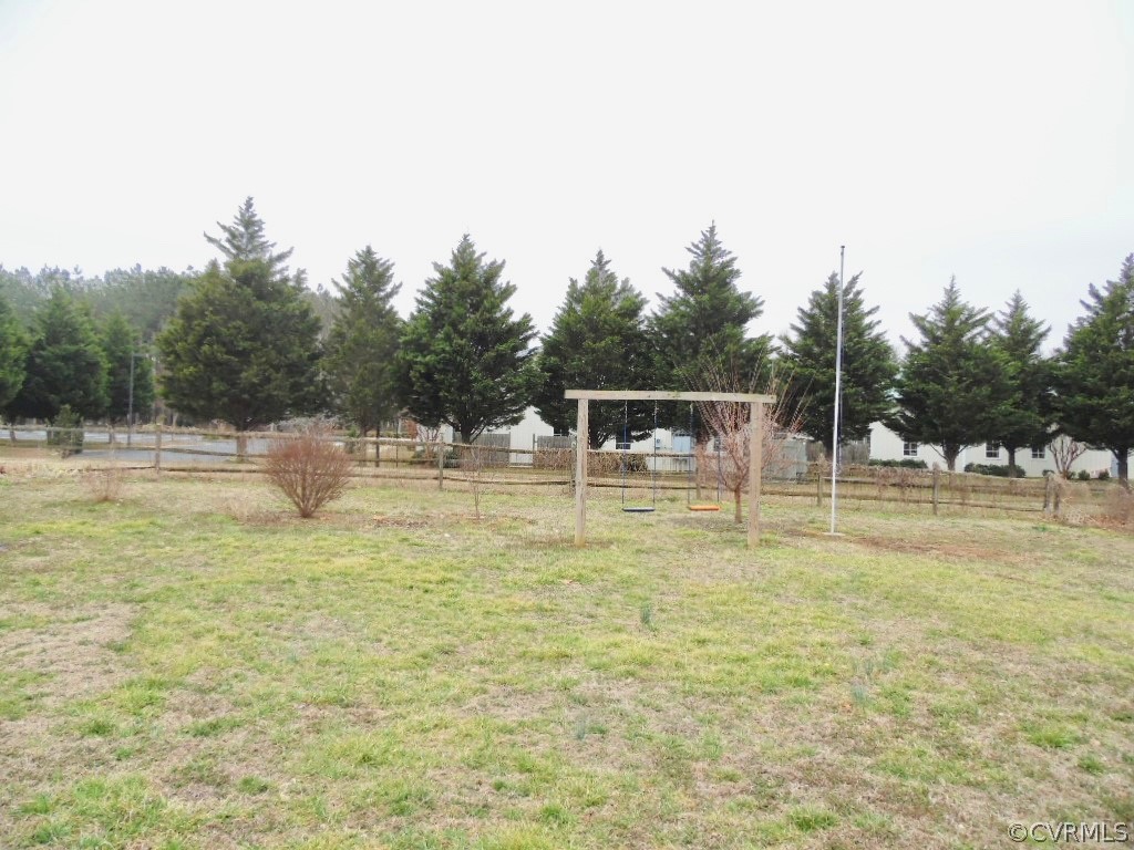 7760 Drexelbrook Road Chesterfield, VA 23832 - Photo 5 of 24 a swimming pool that has lawn chairs with wooden fence