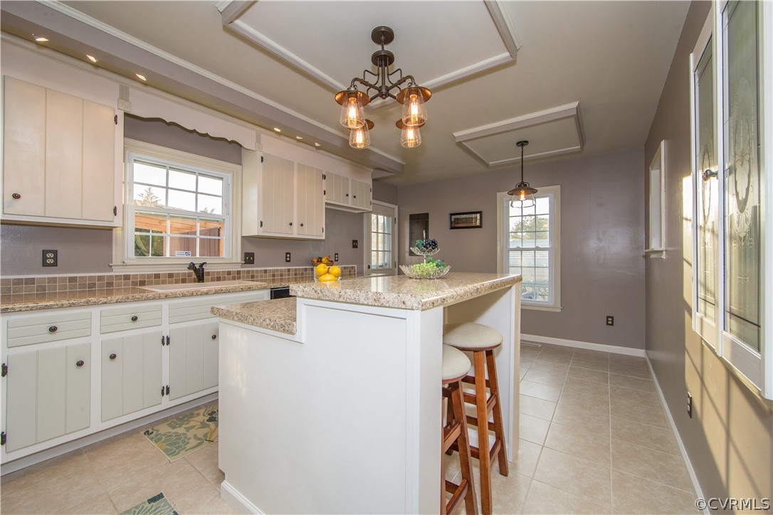 7760 Drexelbrook Road Chesterfield, VA 23832 - Photo 8 of 24 a kitchen with kitchen island granite countertop a sink appliances cabinets and a large window