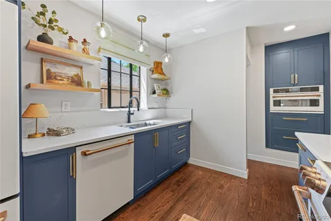 a kitchen with sink cabinets and wooden floor