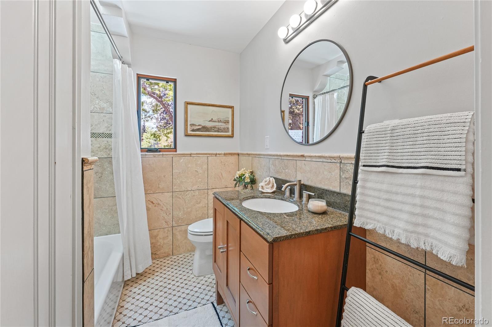 1375 Birch Street Denver, CO 80220 - Photo 15 of 27 a bathroom with a sink and a mirror