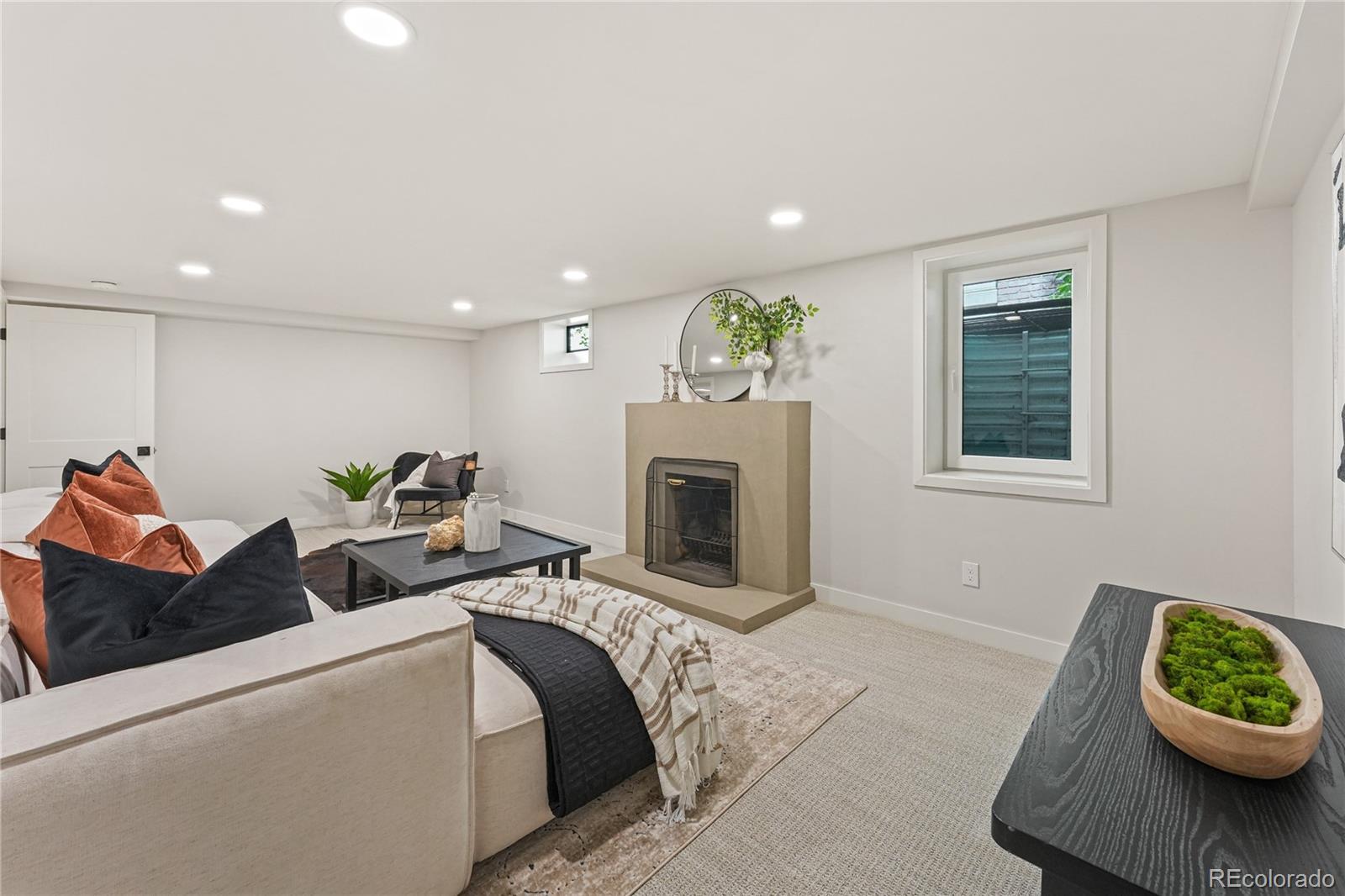 1375 Birch Street Denver, CO 80220 - Photo 17 of 27 a living room with furniture and a fireplace