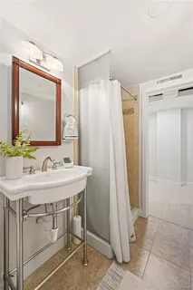 a bathroom with a sink a mirror and a shower
