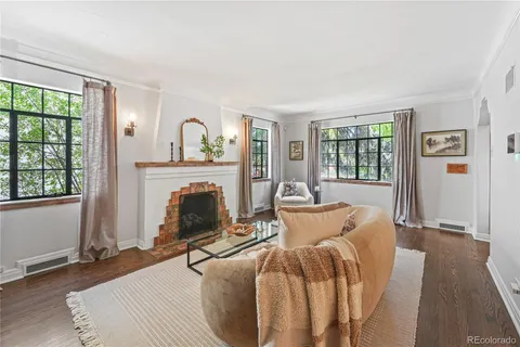 a living room with furniture a fireplace and a table