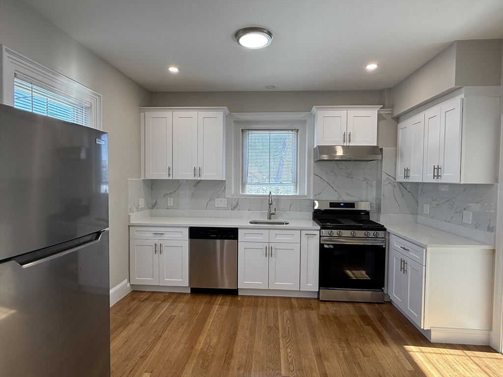 6 Channing Street, Unit 2 Newton, MA 02458 - Photo 1 of 17 a kitchen with granite countertop a refrigerator stove and sink