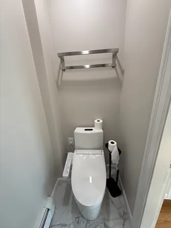 a toilet sitting in a bathroom next to a sink