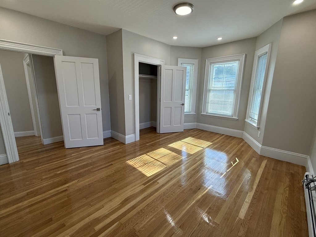 6 Channing Street, Unit 2 Newton, MA 02458 - Photo 15 of 17 a view of a livingroom with wooden floor and bathroom