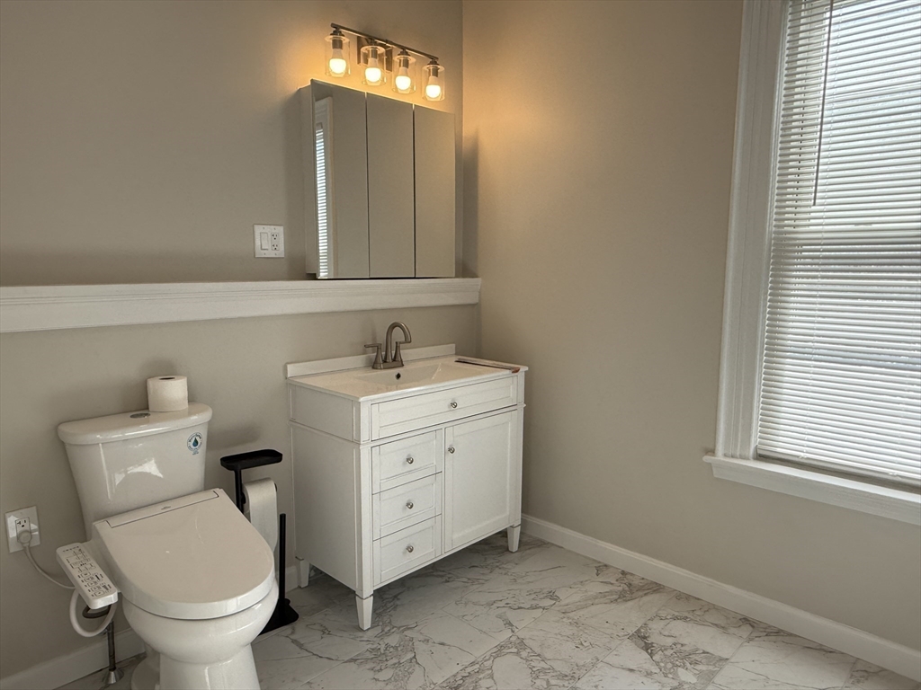 6 Channing Street, Unit 2 Newton, MA 02458 - Photo 16 of 17 a bathroom with a toilet sink and mirror